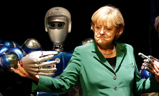 Illustration for article titled Why Is Angela Merkel Always Palling Around With Robots?